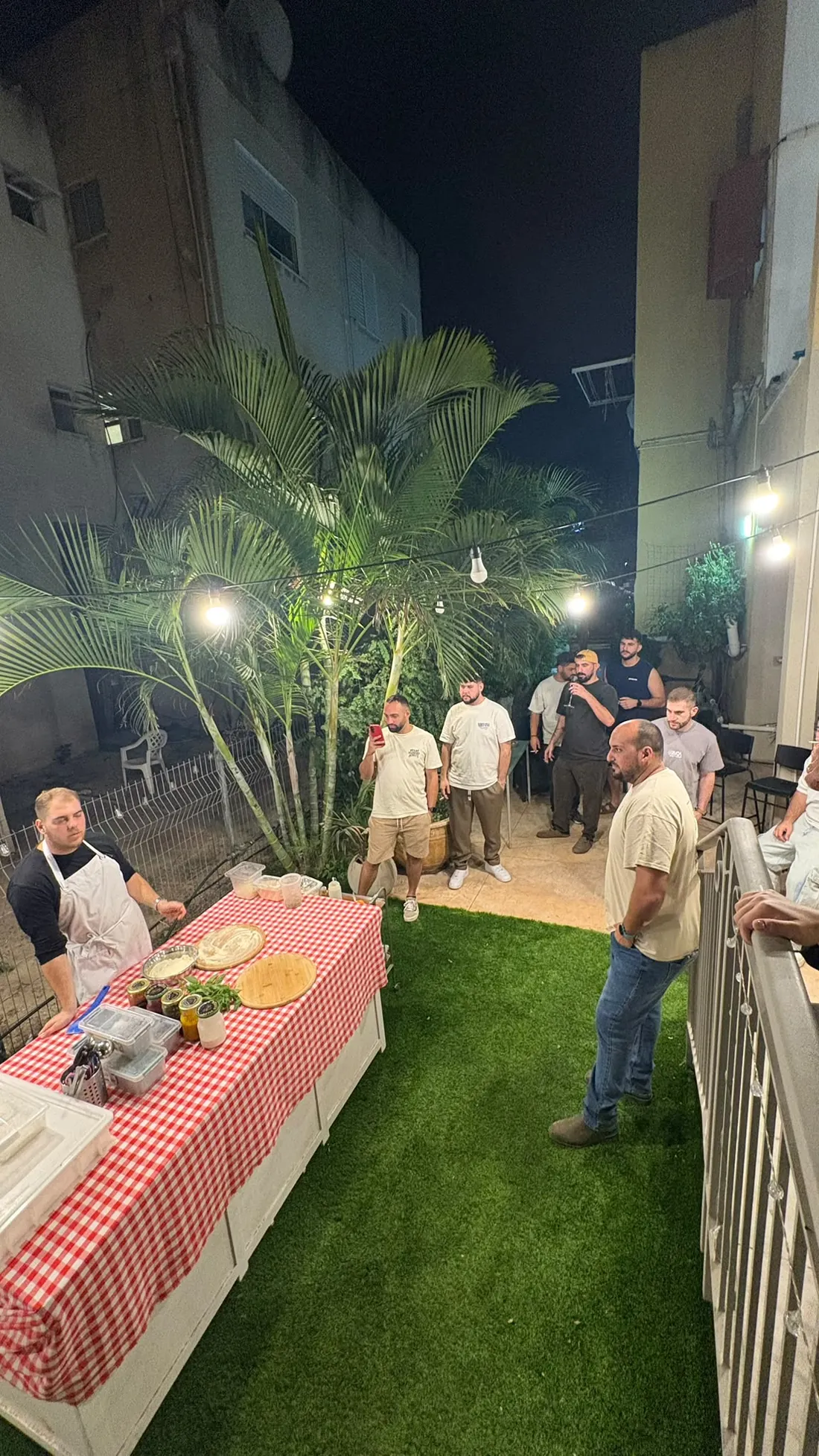 ערב אירוע אמיתי של סבוס פיצה: אורחים סביב שולחן ערוך בגינה